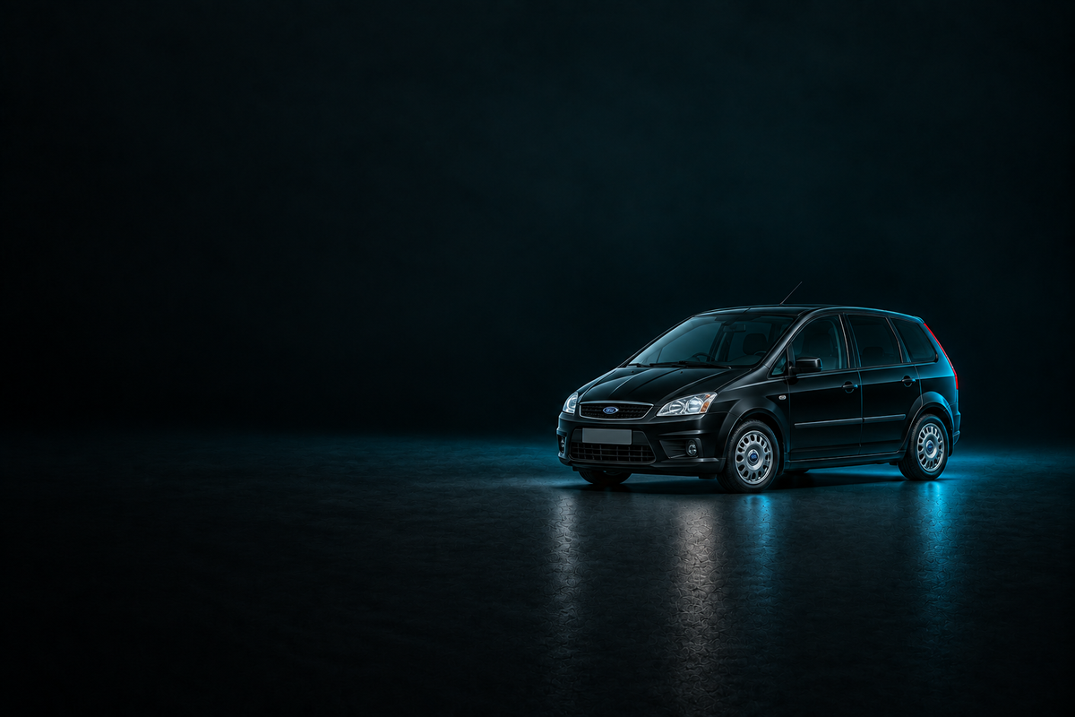 Black Ford C-Max compact MPV in a dark studio with cyan rim lighting.
