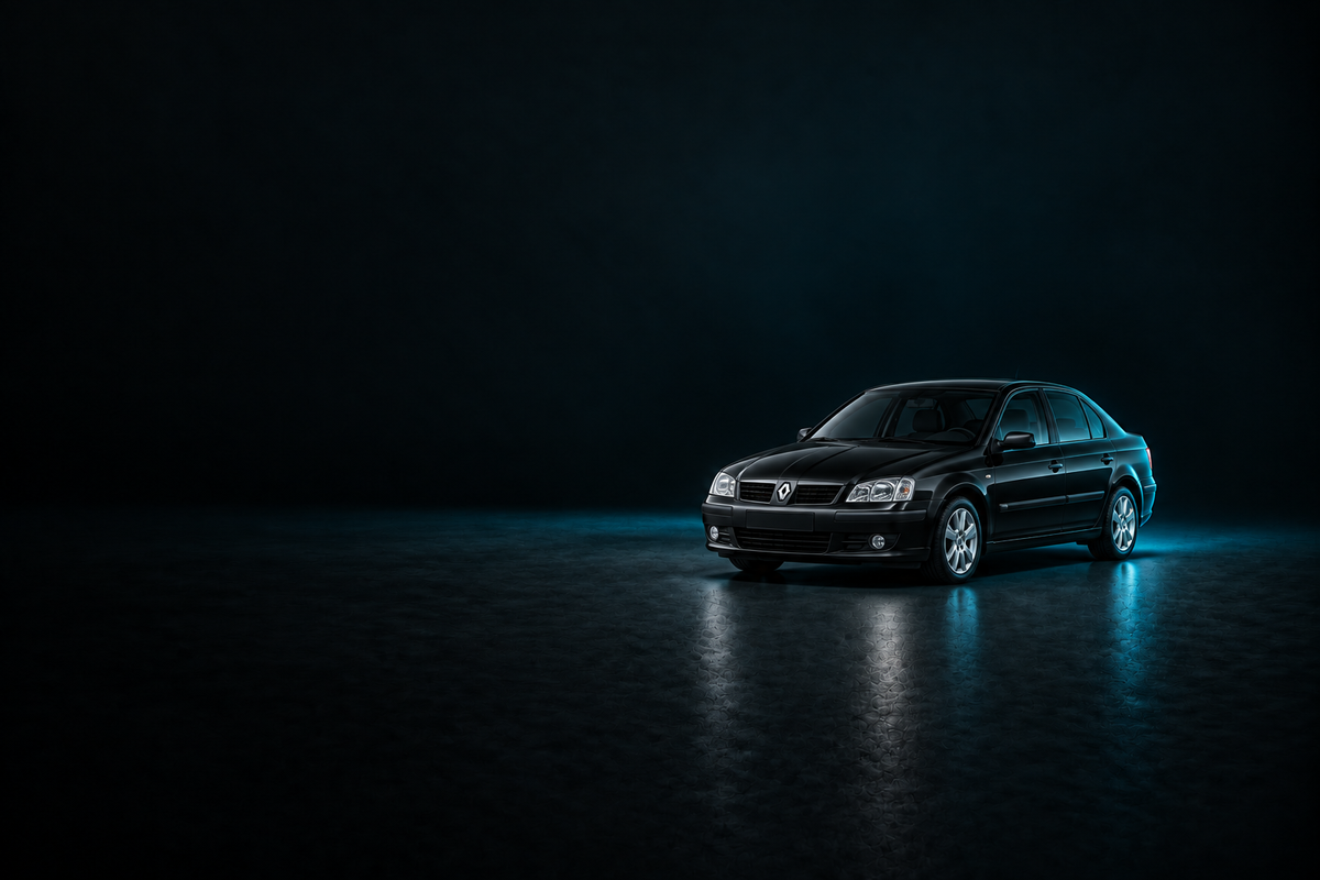 Black Renault Megane saloon on a dark charcoal floor with cool blue lighting.