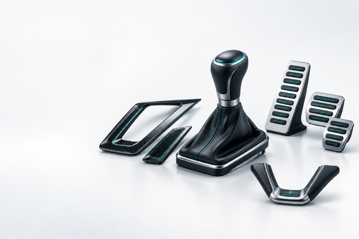Car gear knob and shift boot with interior trim and alloy pedal covers.