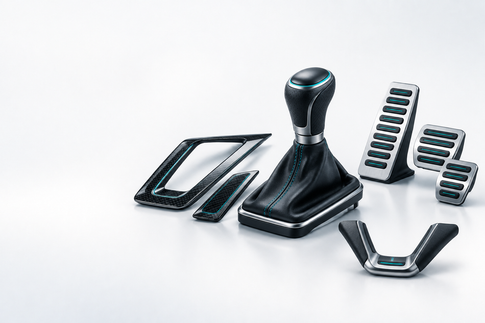 Car gear knob and shift boot with interior trim and alloy pedal covers.