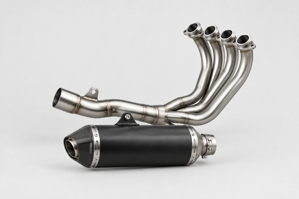 Motorcycle exhaust headers and silencer on a light grey background.