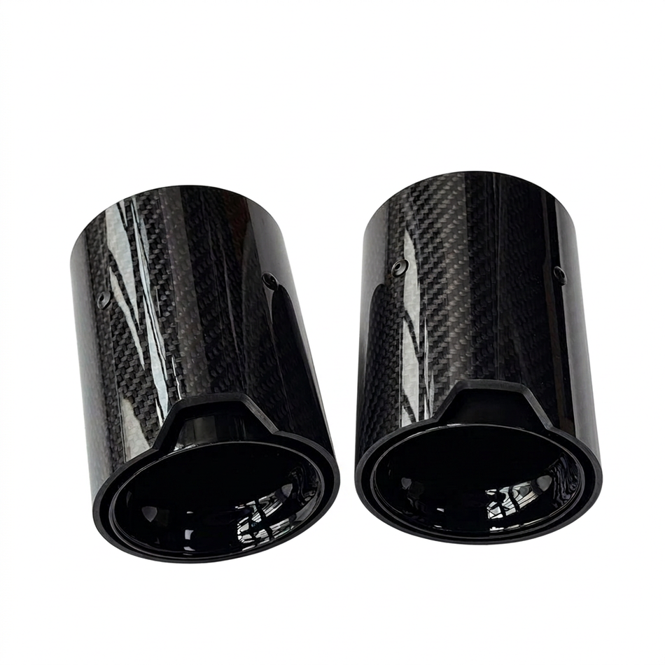 Glossy carbon fibre exhaust tips on a white background without branding
